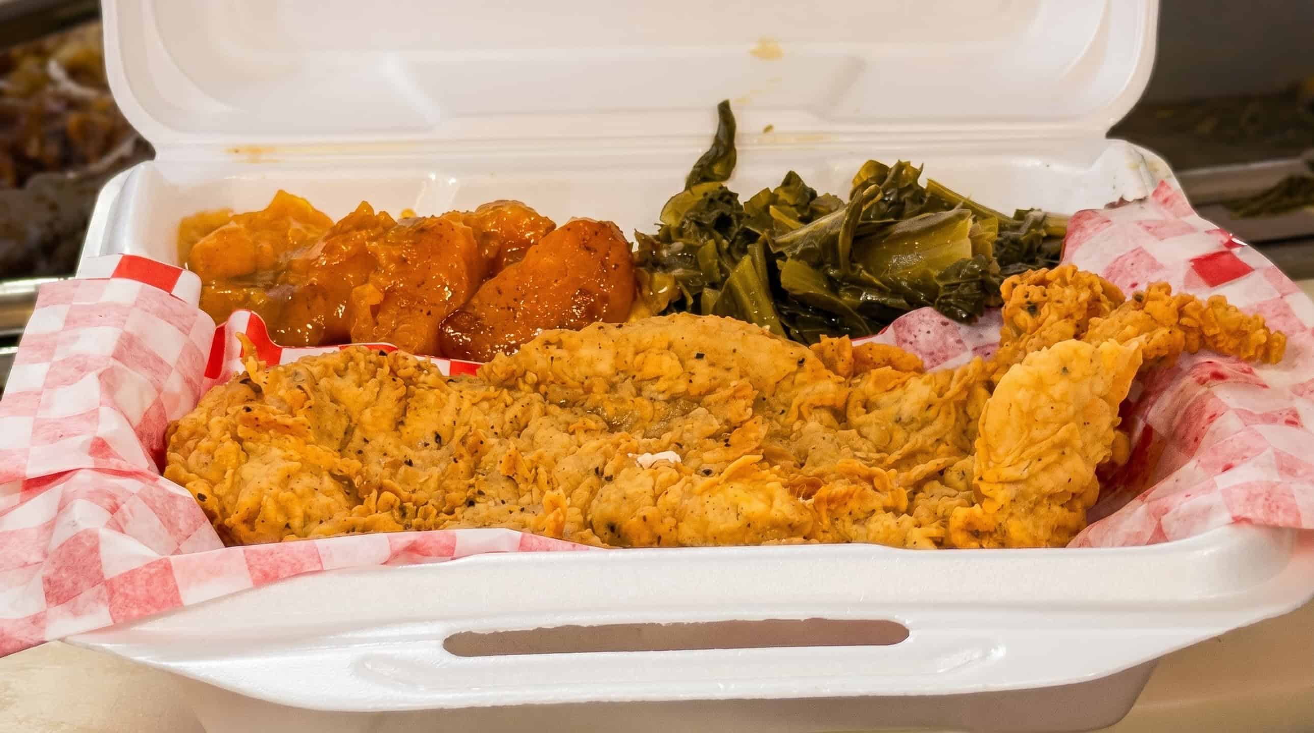 Chicken fried steak smothered in country gravy with Southern sides